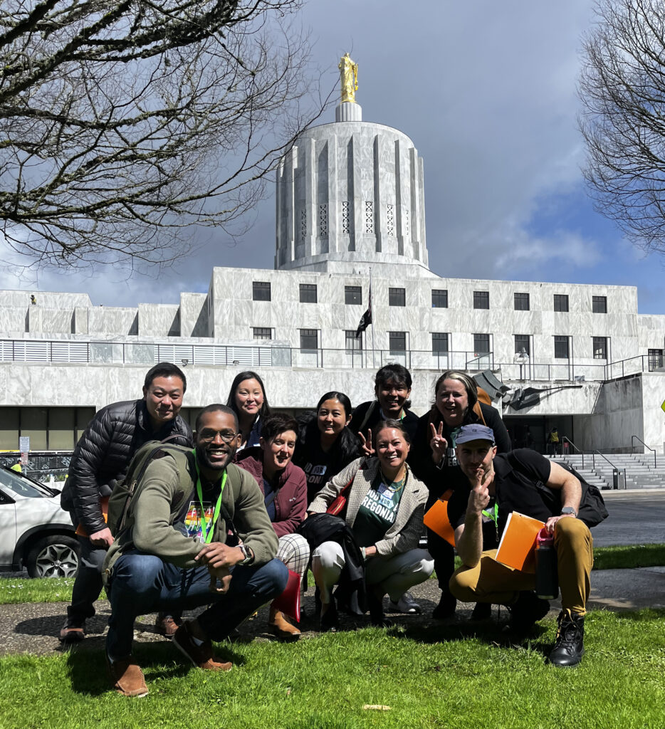 About 10 supporters gather for a photo in front of the Oregon State Capitol on advocacy day 2023